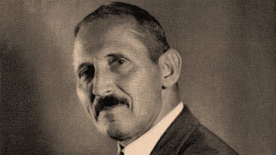 Eduard Reichenow Slightly sideways black-and-white photograph of Eduard Reichenow with his arms crossed and a cigarillo in his right hand