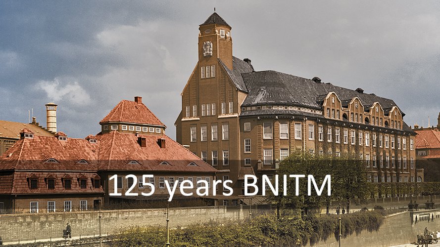About us Historical building with striking architecture in front of a cloudy sky. Text: ‘125 years of BNITM’