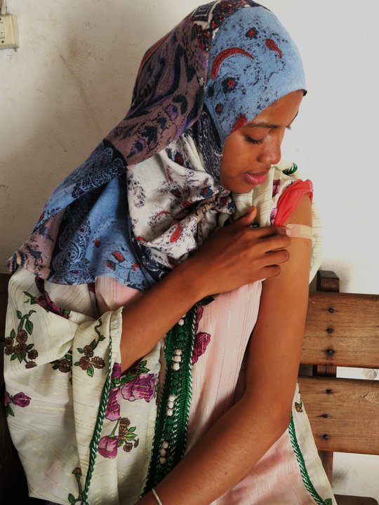 Women after Vaccination Sitting women after Vaccination point on the vacination area on her arm