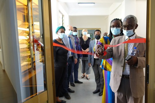 Inauguration of the entomology wing The picture shows the inauguration of the entomology wing of the KCCR. A woman and a man cut the red ribbon to the laboratory together. Behind them is a group of African and European people.