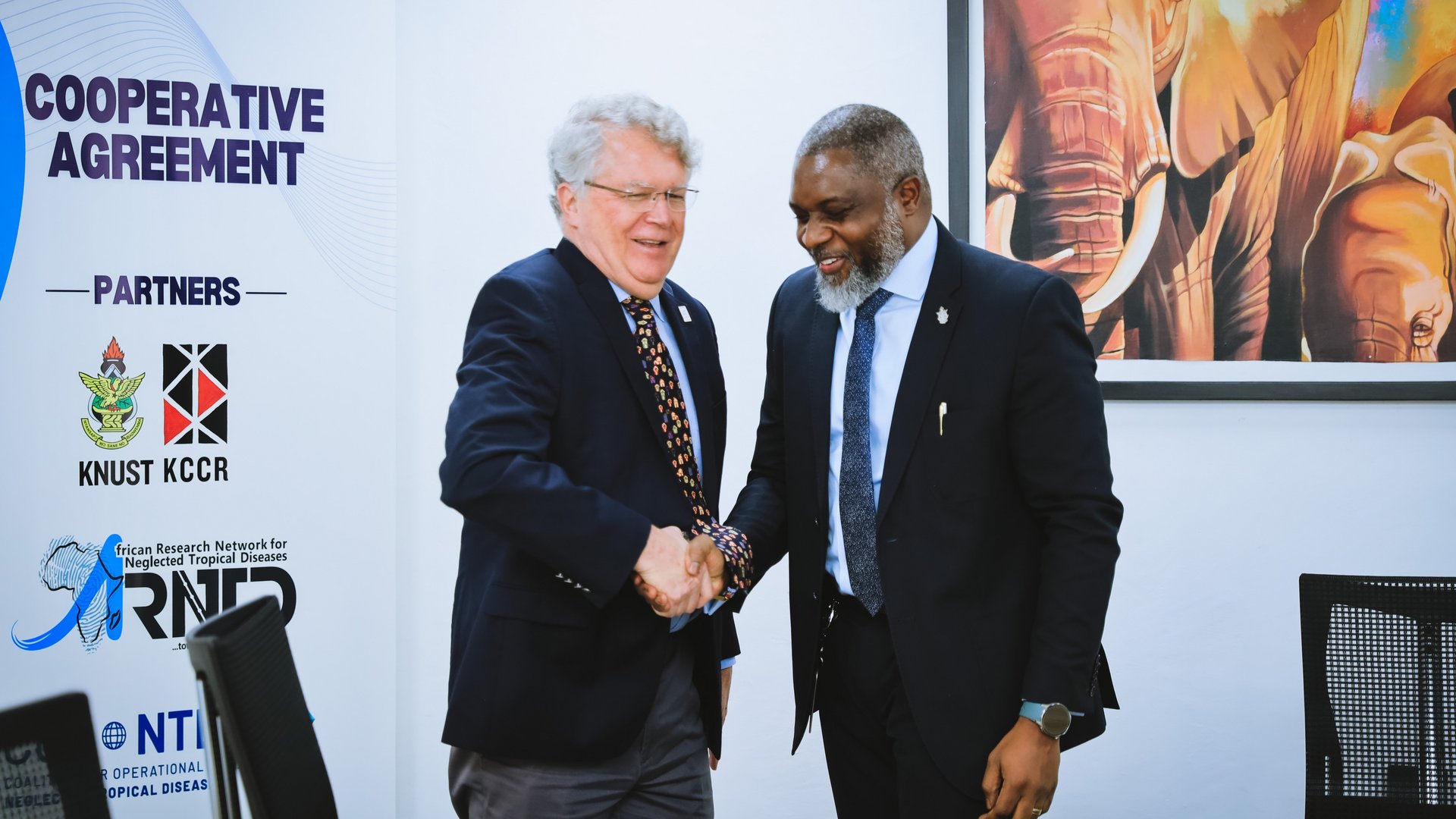 Prof John Amuasi and Dr Pat Lami shaking hands Prof John Amuasi and Dr Pat Lami shaking hands