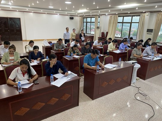 The picture shows participants completing a knowledge test during the training in Laos The picture shows participants completing a knowledge test during the training in Laos.
