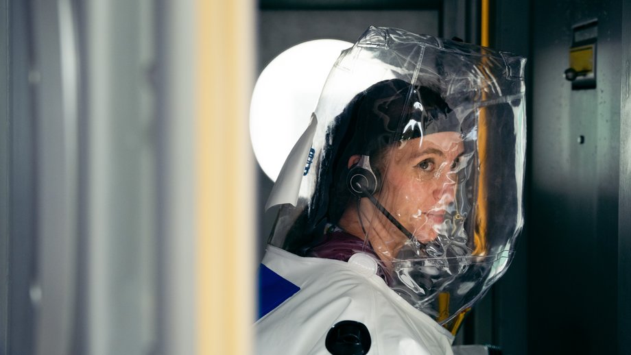 Cover Scientist in a protective suit