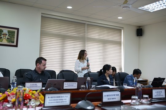 Dr. Jade Rae presenting an overview of the VIPER-App study. The picture shows a woman speaking into the microphone while three other people look at the presentation.