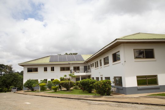 The main entrance of KCCR The picture shows the two-storey main building of the KCCR with light green roof and solar system.