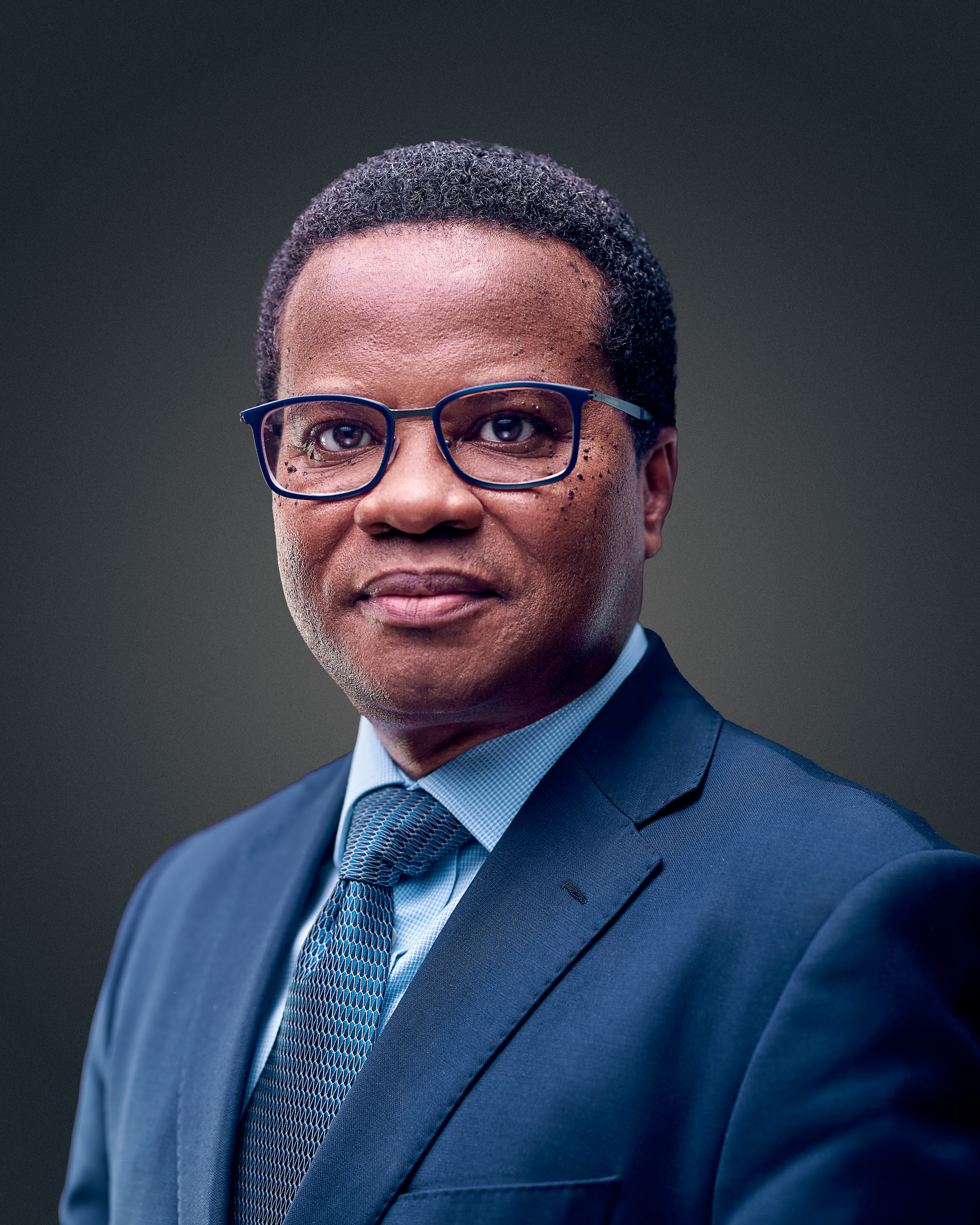 Prof. Richard Phillips, Scientific Director of KCCR The picture shows a self-confident middle-aged African scientist in a blue suit with a light blue tie and black-rimmed glasses.